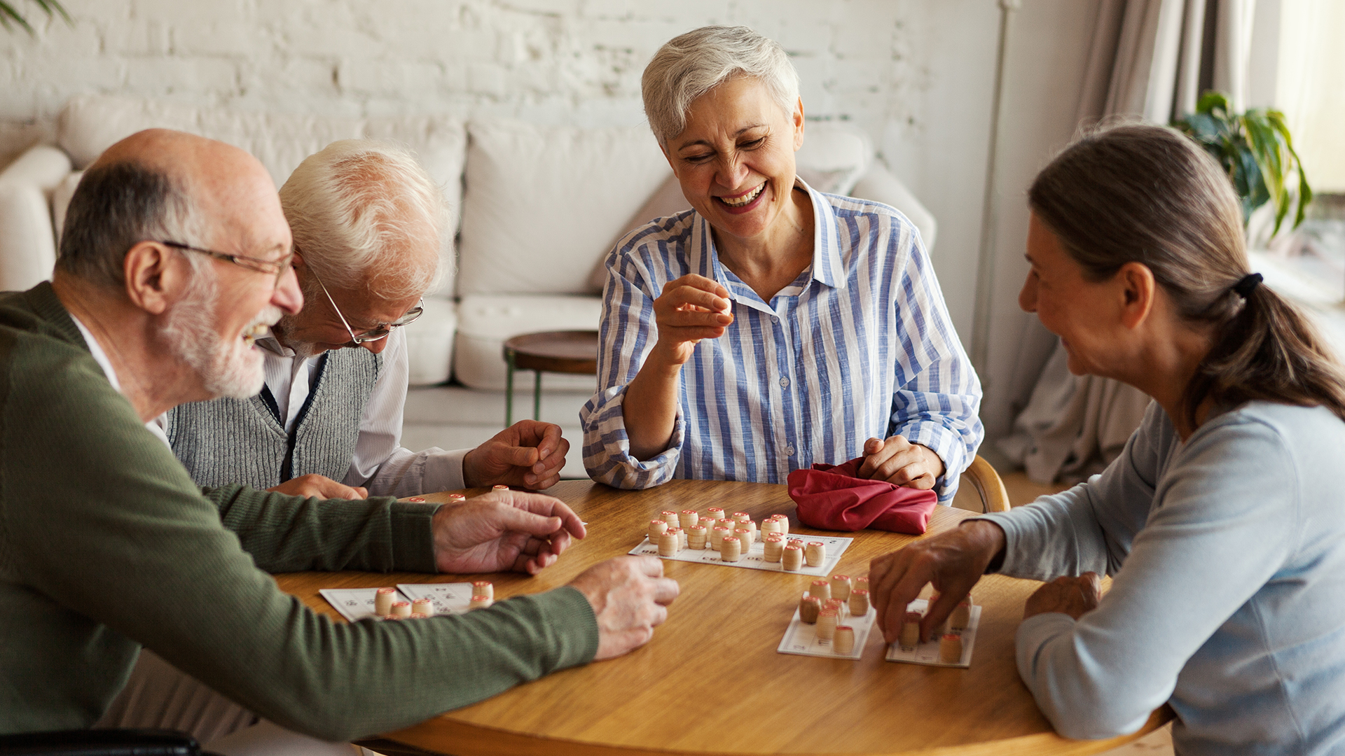 seniors living an active retirement playing games in their home at ginger cove