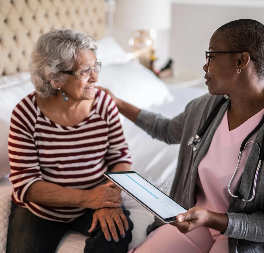 assisted-living-caregiver Nurse places hand on senior woman's shoulder