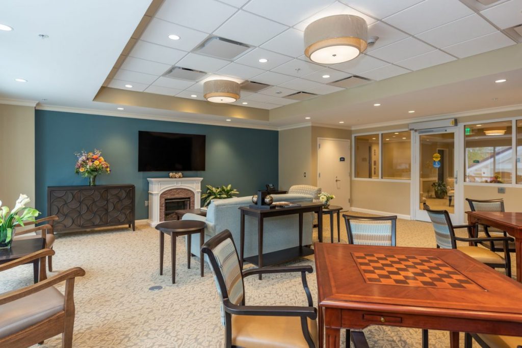 Ginger Cove Independent Living common area with fireplace and tv