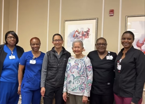 Ginger Cove employees smiling with resident