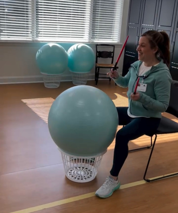 Ginger Cove employee leading session with therapy bull drums