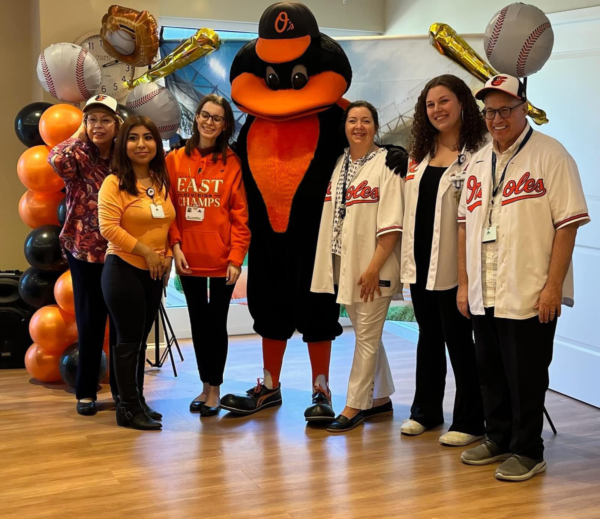 Ginger Cove employees smiling with Orioles mascot