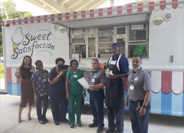 Ginger Cove employees smiling in front of ice cream truck