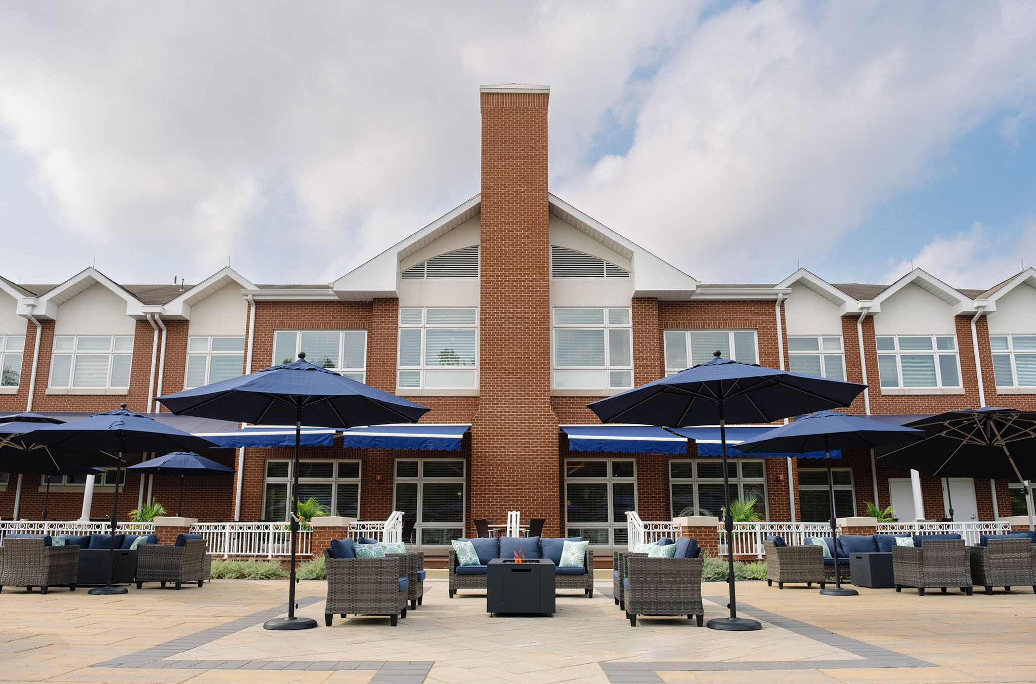 Ginger Cove outdoor patio tables and couches around firepit