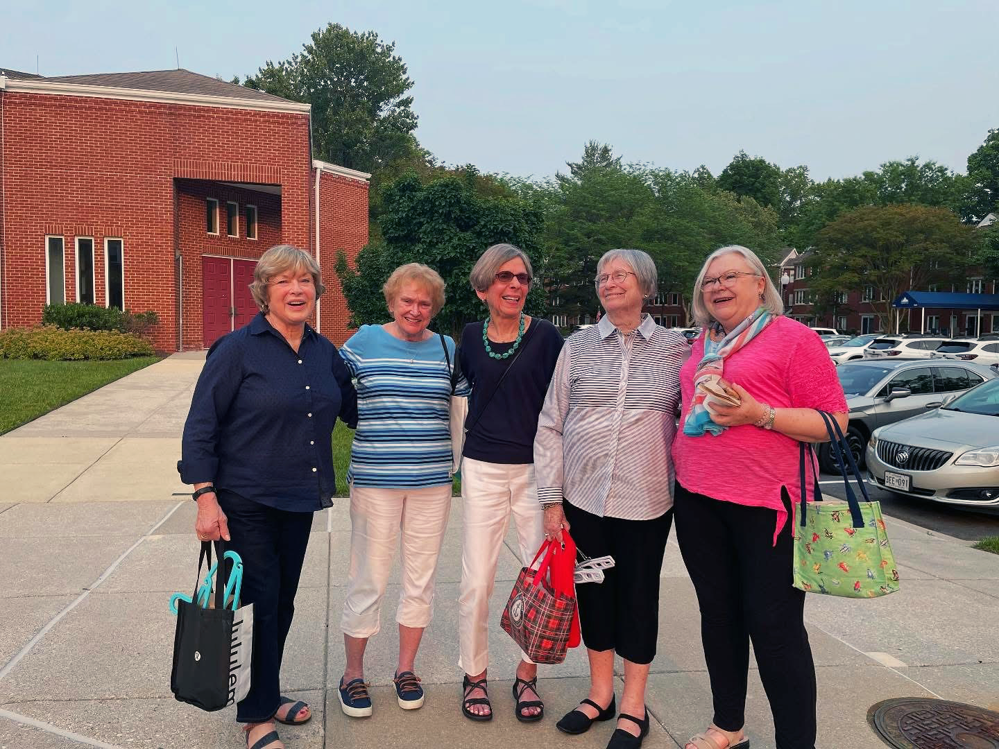 Group of five Ginger Cove residents smiling for the camera. 