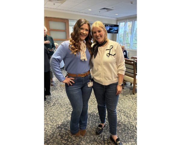 Two Ginger Cove employees wearing retro outfits for Halloween