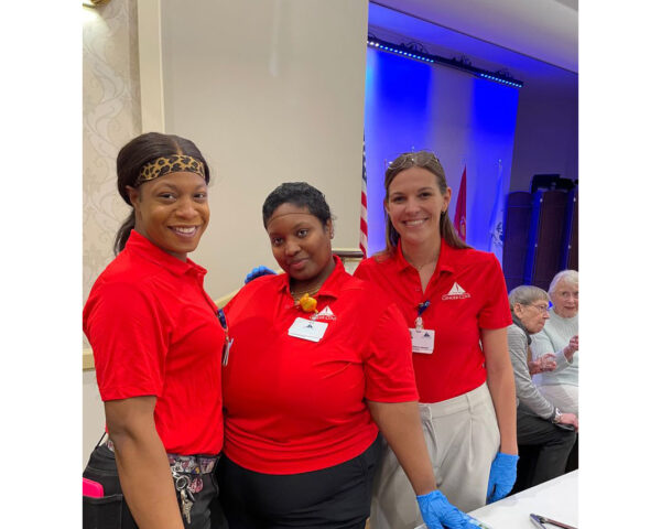 Three Ginger Cove employees standing and smiling at camera.