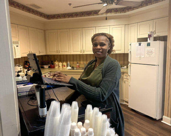 Ginger Cove employee at laptop