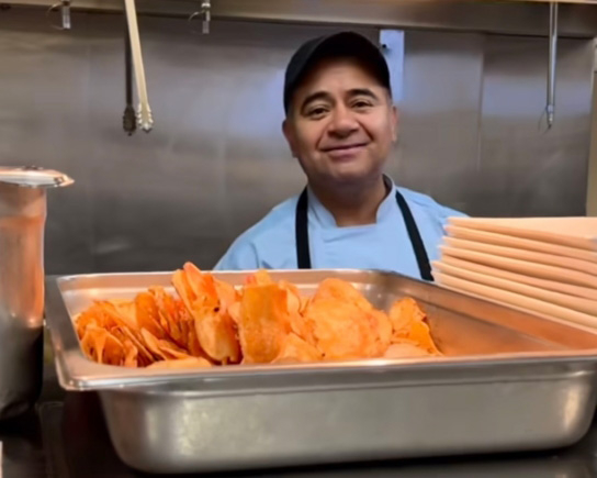 Ginger Cove kitchen employee smiling
