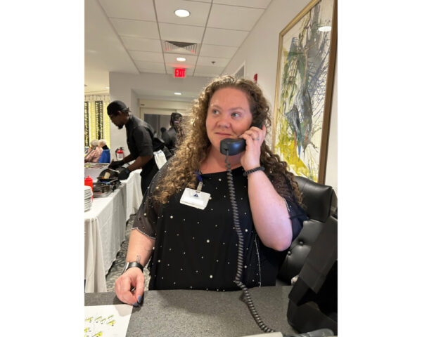 Ginger Cove employee answering phone