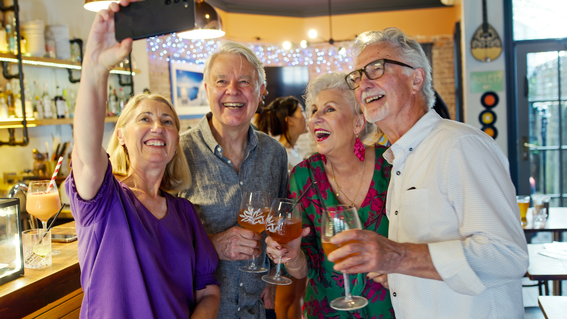 Four seniors posing for selfie
