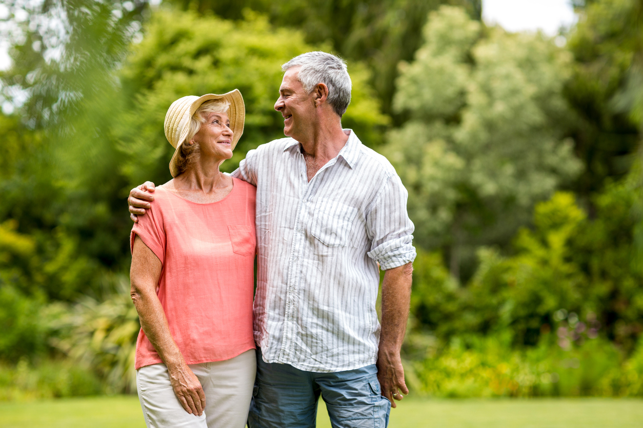 Senior couple standing in yard Senior couple standing in yard in summertime